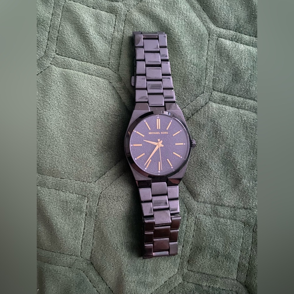 Women’s black and gold Michael Kors watch